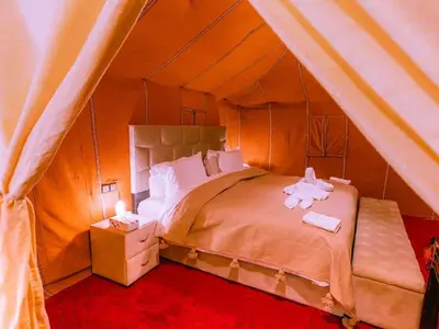 a bedroom with a bed in a tent at Serenity Sky Luxury Camp in Merzouga