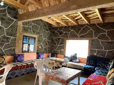 a living room with a couch and a table at Gite Itran Taghia in Taghia