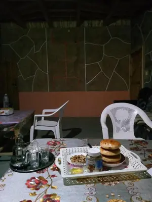 a table with a plate of food on top at Gite Itran Taghia in Taghia