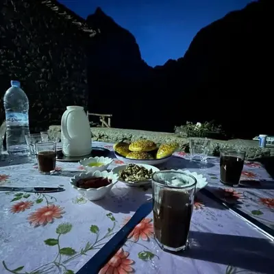 a table with plates of food and drinks on it at Gite Itran Taghia in Taghia