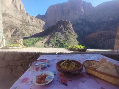 a table with a bowl of food on top of a mountain at Gite Itran Taghia in Taghia