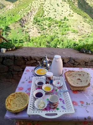 a table with plates of food on top at Gite Itran Taghia in Taghia