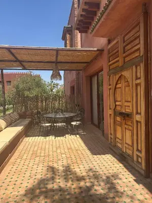 a patio with a table and chairs on it at Riad du Bab atlas in Marrakech