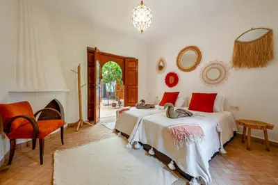 a bedroom with two beds and a fireplace at Riad du Bab atlas in Marrakech