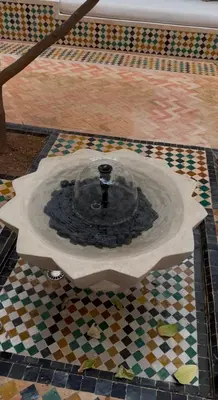 a fountain on top of a tiled floor at Riad du Bab atlas in Marrakech