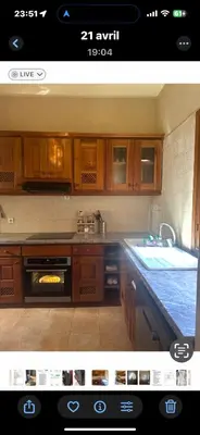 a kitchen with wooden cabinets and a stove top oven at Riad du Bab atlas in Marrakech
