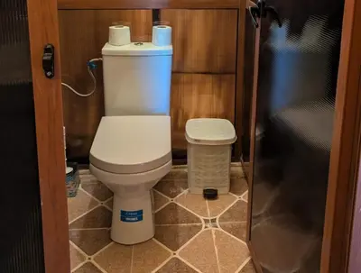 a small bathroom with a toilet and a trash can at Sania Luxury Camp in Merzouga