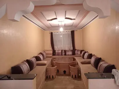 a waiting room with a long couch and chairs at Billa appart in Midelt