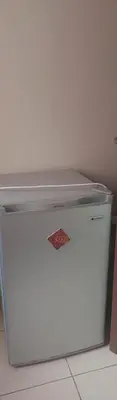 a white refrigerator freezer sitting in a kitchen at Casa De La Mama chauffée cosy et climatisée 3 pièces Ifrane sous la neige in Ifrane