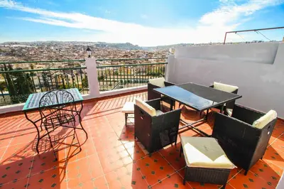 a patio with a table and chairs on a balcony at Riad Zaya Fes in Fès