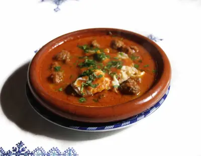 a bowl of soup on a plate on a table at Riad Zaya Fes in Fès
