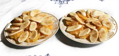 two bowls of bananas and oranges on a table at Riad Zaya Fes in Fès