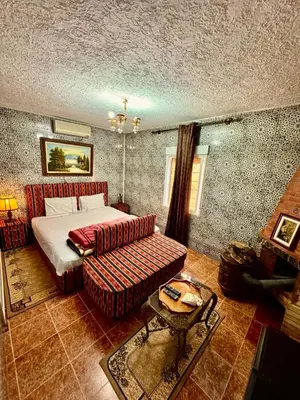 a bedroom with a bed and a couch at Auberge Sous Les Étoiles Lac Ouiouane in Kasba des Aït Athmane