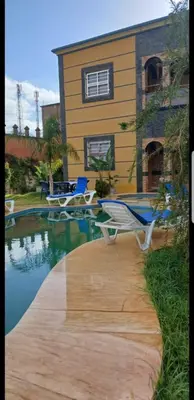a house with a pool and chairs next to it at Villa Sarghini in Sidi Bouzguia