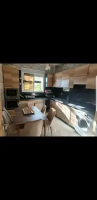 a kitchen with a table and chairs in a room at Villa Sarghini in Sidi Bouzguia