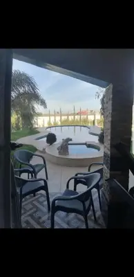 a group of chairs sitting in front of a fountain at Villa Sarghini in Sidi Bouzguia