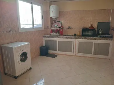 a kitchen with a washing machine and a window at Billa appart in Midelt
