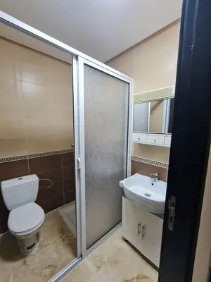 a bathroom with a toilet and a sink at Fes Magic Apartment - With Swimming pool in Fès