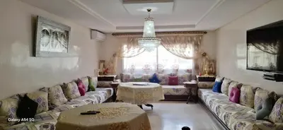 a living room with couches and a table at Fes Magic Apartment - With Swimming pool in Fès