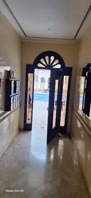 an open door to a room with a pool at Fes Magic Apartment - With Swimming pool in Fès