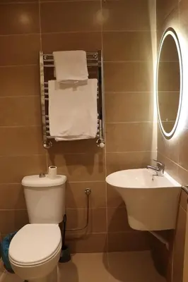 a bathroom with a toilet and a sink and a mirror at VANA hôtel in Midelt