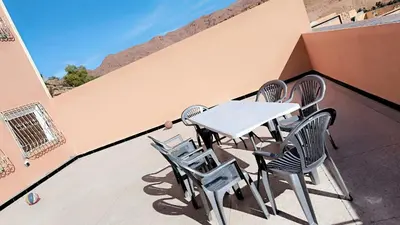 a white table and chairs on a balcony at Home Amazigh Serenity in Tinerhir
