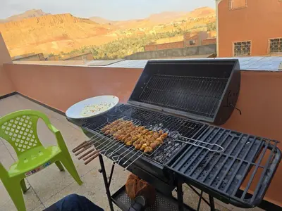 a grill with a laptop sitting on top of it at Home Amazigh Serenity in Tinerhir