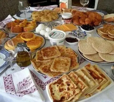 a table topped with lots of different types of food at Home Amazigh Serenity in Tinerhir