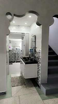a bathroom with a sink and a staircase at Home Amazigh Serenity in Tinerhir