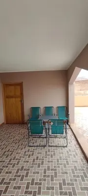 a room with a table and chairs and a door at Home Amazigh Serenity in Tinerhir