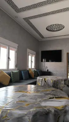 a living room with a couch and a large bed at Home Amazigh Serenity in Tinerhir