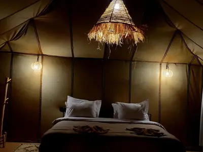 a bedroom with a large bed in a tent at Golden Gate Luxury in Merzouga