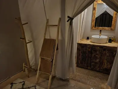 a bathroom with a sink and a mirror at Golden Gate Luxury in Merzouga