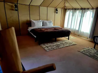 a bedroom with a bed in a tent at Golden Gate Luxury in Merzouga