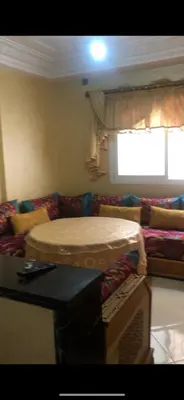 a living room with a bed on a couch at منزل شامة in Moulay Yacoub