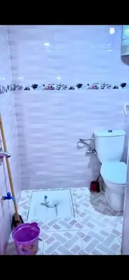 a bathroom with a toilet and a shower stall at منزل شامة in Moulay Yacoub