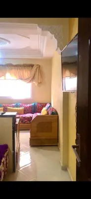 a living room with a couch and a bed at منزل شامة in Moulay Yacoub