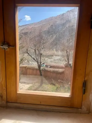 a window with a view of a mountain at Gite d'étape Chez Brahim in Kalaat MGouna