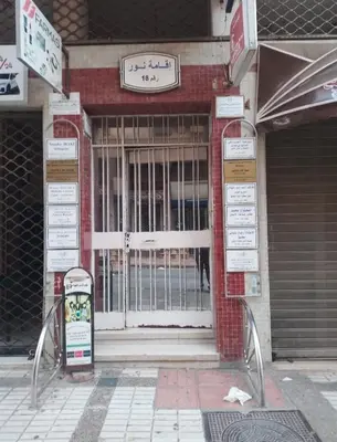 an entrance to a building with a gate at Cyrnos in Fès
