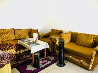 a living room with a couch and a table at Cyrnos in Fès