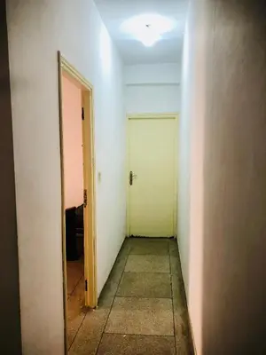 an empty hallway with a door and a mirror at Cyrnos in Fès