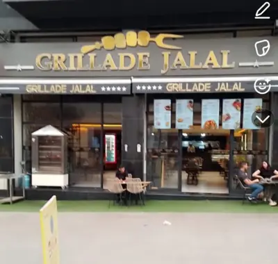 a restaurant with people sitting at tables in front of it at Cyrnos in Fès