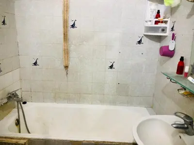 a bathroom with a bath tub and a sink at Cyrnos in Fès