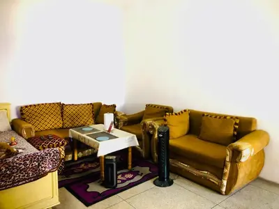 a living room with two couches and a table at Cyrnos in Fès