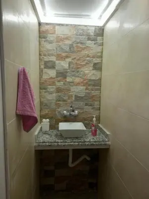 a bathroom with a sink and a stone wall at ain chekef in Douar Oulad Mhammed