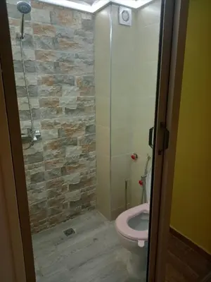 a bathroom with a toilet and a walk in shower at ain chekef in Douar Oulad Mhammed