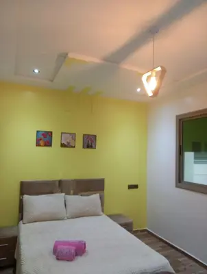 a bedroom with a large bed with a pink object on it at ain chekef in Douar Oulad Mhammed