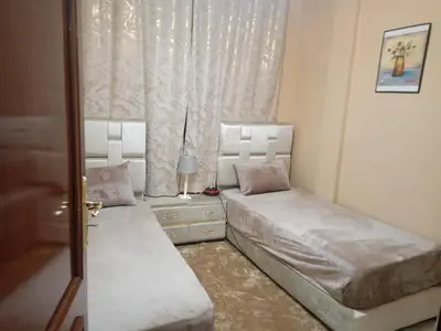 a bedroom with two beds and a window at Gîte du lac chez bennouri in Telouet