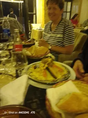 a woman sitting at a table with a plate of food at Gîte du lac chez bennouri in Telouet
