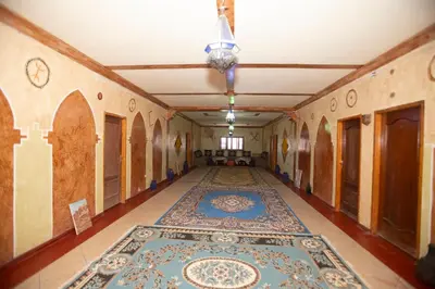 an empty hallway with a rug on the floor at Kasbah Tasseurte in Kalaat MGouna
